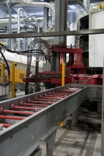 Washers of various sizes are stacked on a piston rod for assembly, with differing levels of air and oil fill to suit the specifications of the individual products at ThyssenKrupp; modular, programmable work cells provide great flexibility in production. 