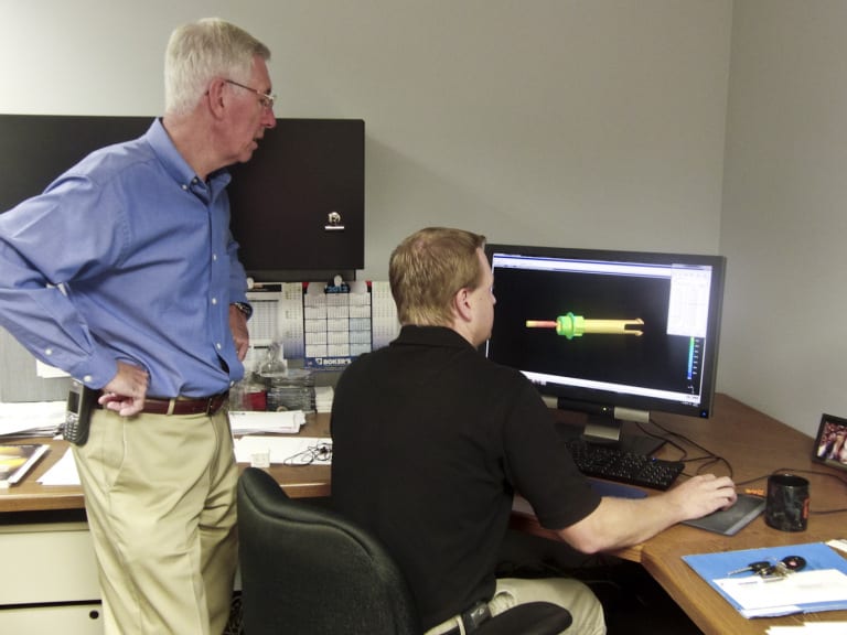 Eric Frearson, Vice President of Engineering, Tessy Plastic (Left) and Stafford Frearson, Project Engineer at Tessy Plastics, discuss a SIGMASOFT screen at Tessy Plastics in Elbridge, NY.