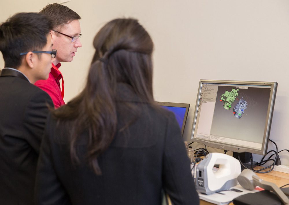 Attendees visualizing scanned data with Exact Metrology personnel