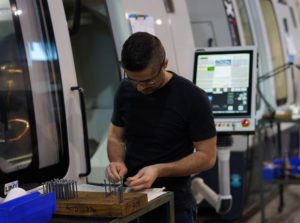 Abraham meticulously inspecting the incoming pieces before grinding